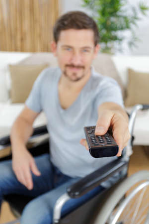 disabled man watching tv at homeの写真素材