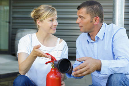 couple and firefighting drill in progressの写真素材