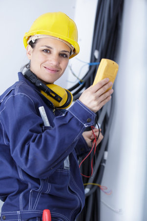female electrician using a multimeter