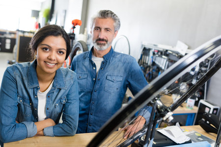 woman and man as bike mechanics in workshop