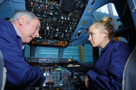 working on cockpit of an airplaneの写真素材