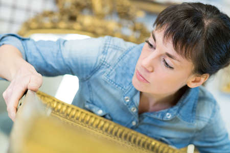 woman holding gilt picture frameの写真素材