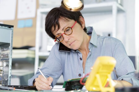 woman on the phone fixing a pc
