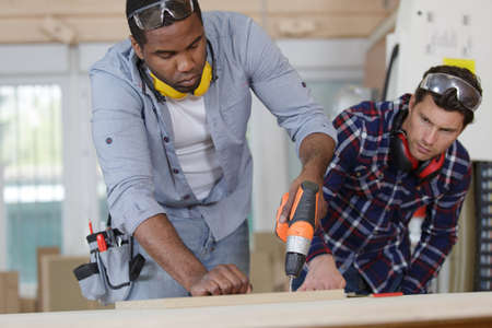 man drilling wood with batteryの写真素材