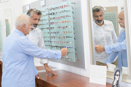 senior testing new glasses with optician