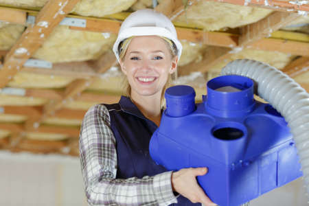 young woman plumber a workの写真素材