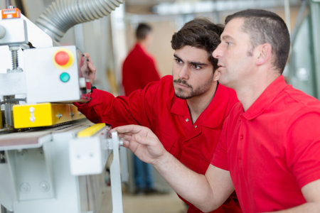 two workers checking parameters of pressure