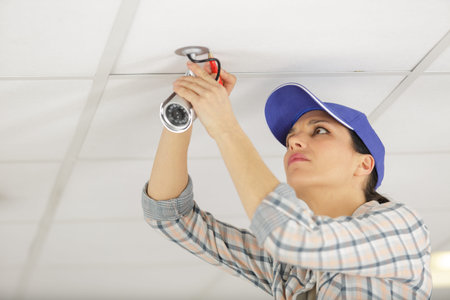 a concentrated woman is cctv installing