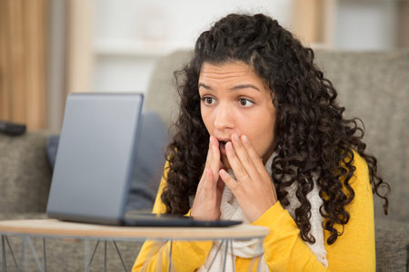 young attractive businesswoman surprised in front of laptop