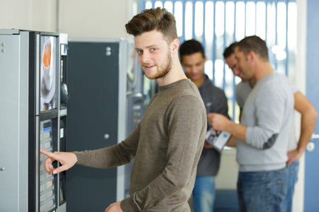 young man using a vending machine