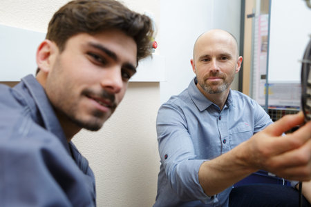 portrait of apprentice and engineer in factoryの写真素材