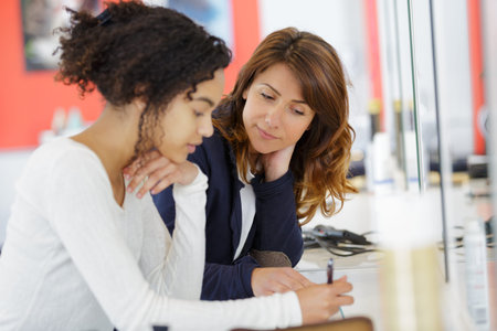female student studying with teacher