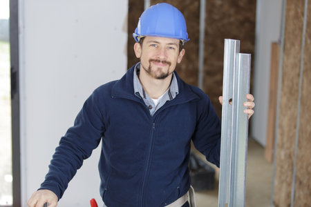 male builder holding metal framework