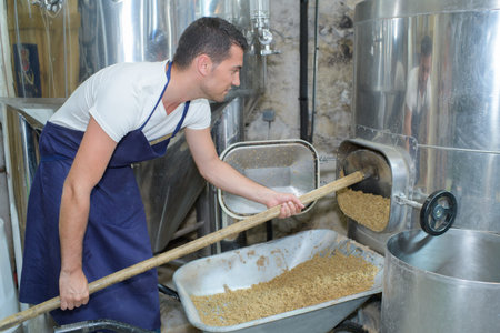beer brewer in his brewery at food tank