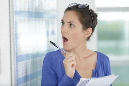 portrait of a surprised woman with pen