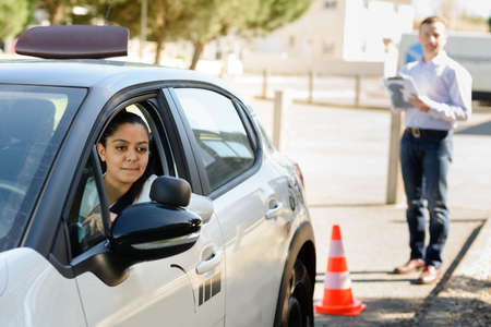 happy woman with car dealer in auto showの写真素材