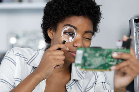 female technician working in electronic laboratoryの写真素材