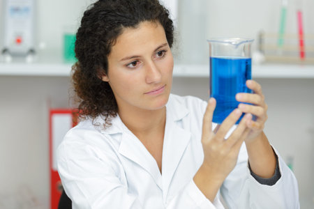 female tech works in chemical lab