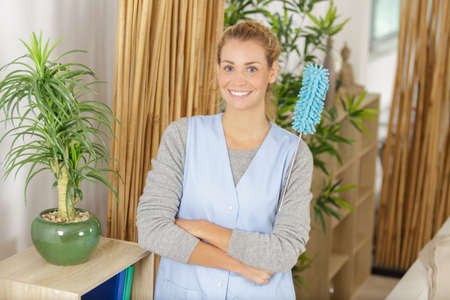 cleaner female is looking at the cameraの写真素材