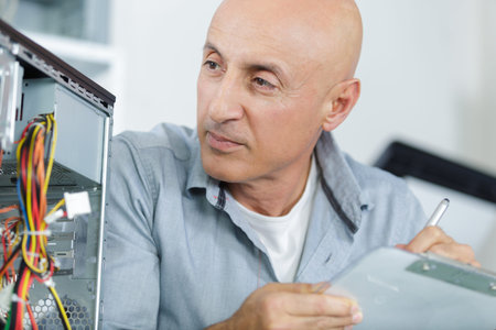 a male technician fixing pc cables