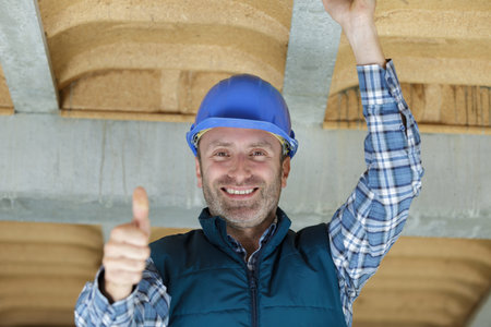 construction worker shows thumb up