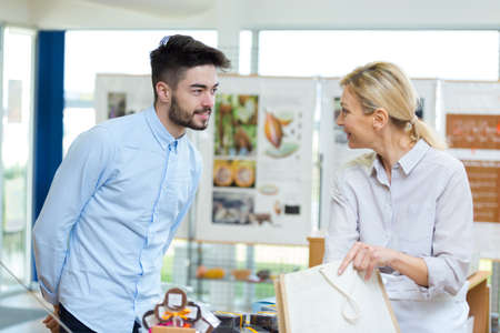 two peopele talking in an artists workshopの写真素材