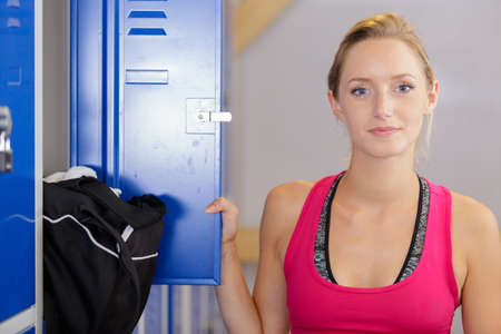 woman opening her gym locker doorの写真素材