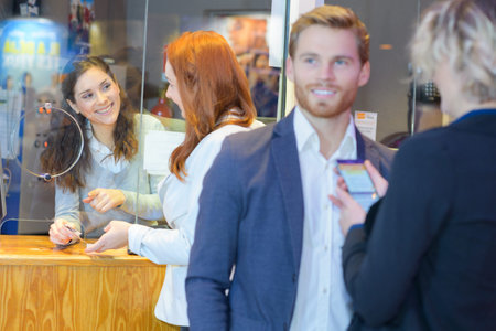 young people buying tickets for show from booth