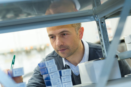 storekeeper near shelves on a warehouse
