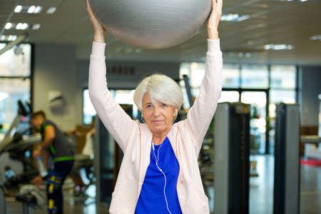 smiling woman holding exercise ballの写真素材
