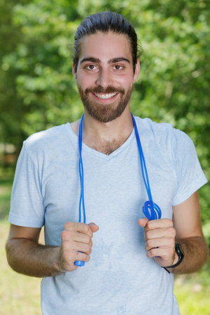 man holding plastic skipping ropeの写真素材