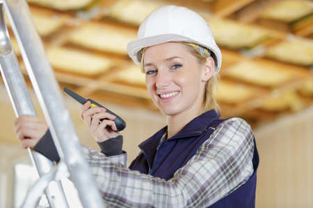 female construction worker using talkie walkieの写真素材