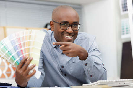 designer graphic creative pointing at swatchesの写真素材