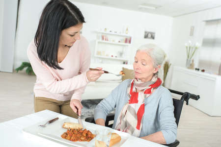 elderly lady on wheelchair and her nurseの写真素材