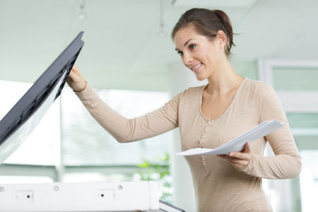 happy teacher printing off work sheets for her next lesson