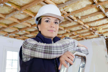 portrait of beautiful woman builder working indoorsの写真素材