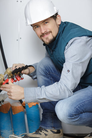 man worker dealing with pipes connection