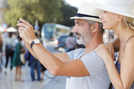 mature couple visiting old city street monumentの写真素材