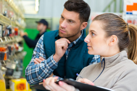 couple buying tools for house decoration in supplies store
