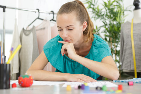 contemplative young female fashion designer