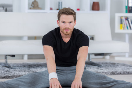 fit young man doing stretching exercise