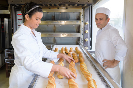 female baker positioning the bread