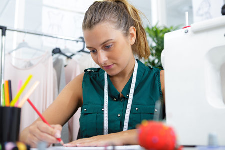 tailor writing in sewing atelier