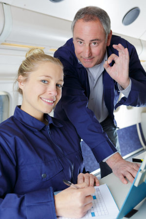 happy workers on final assembly line of aircraft