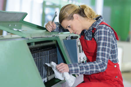 woman fixing cartridge in printer machine at officeの写真素材