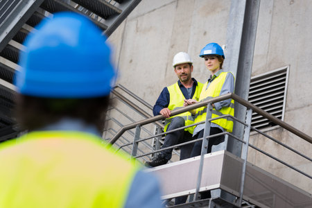 Portrait of engineers discussing outdoors