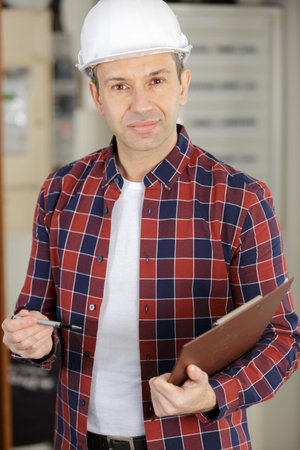 Thoughtful engineer holding a clipboard