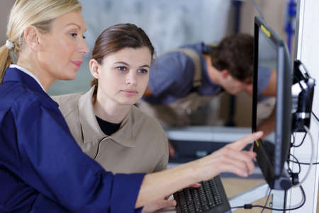 Two entrepreneurs talking in workshopの写真素材