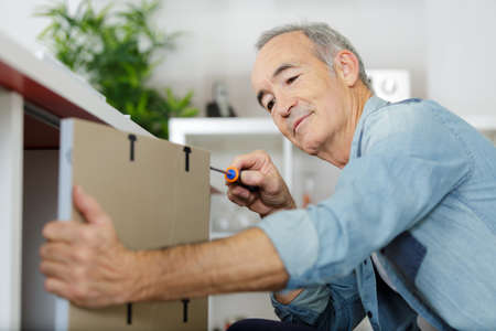 Senior carpenter checking and measures wooden plankの写真素材