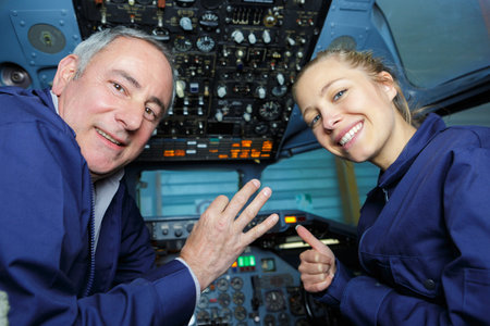 engineers making positive gestures in aircraft cockpit